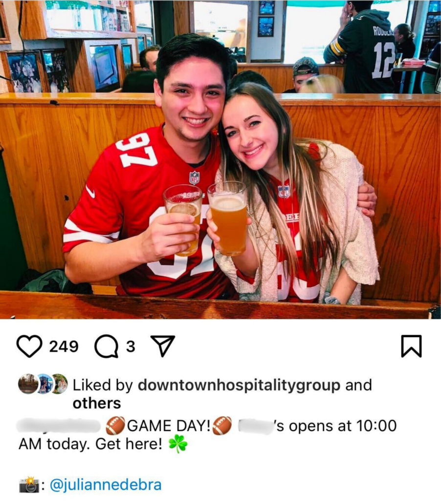 Two smiling customers in 49ers jerseys holding beer glasses at a bar, with a cozy wooden booth and sports decor in the background. The festive vibe highlights game-day celebrations